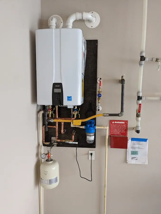 Professional plumber installing copper piping in a Howell home